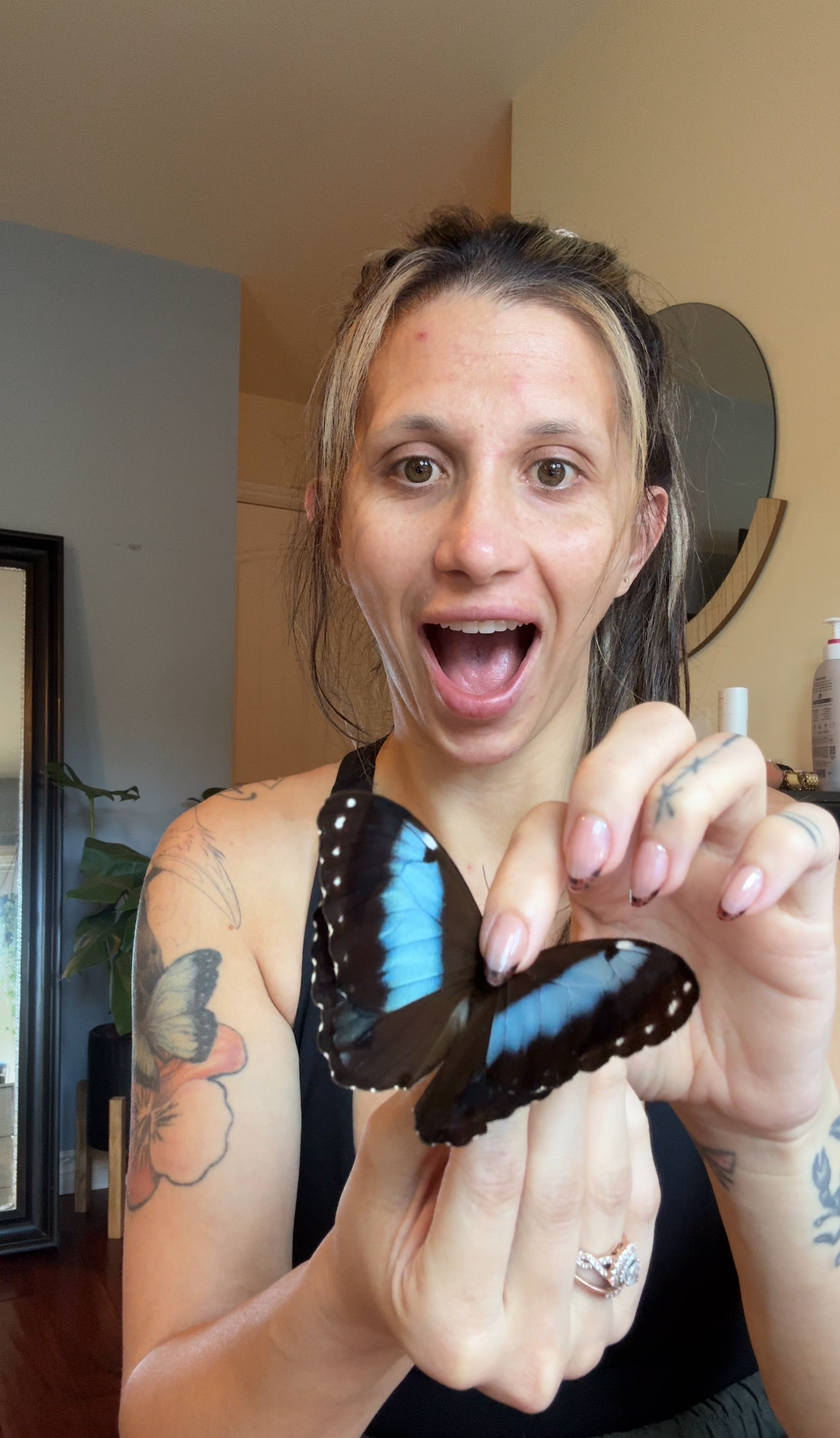 Rae holding a Blue Morpho butterfly — perfect beginner species